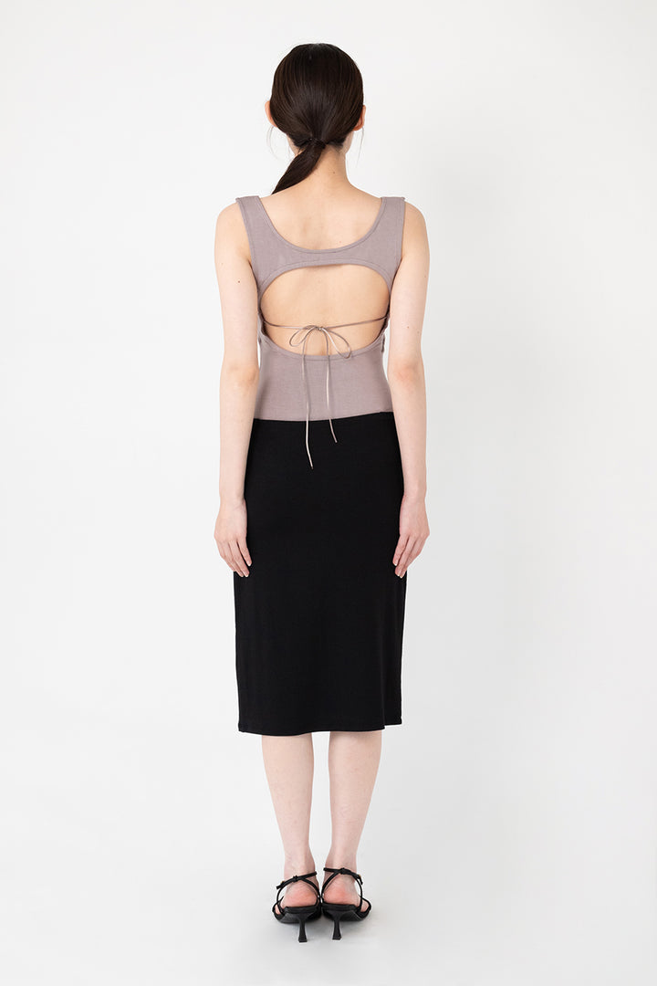 Woman modeling front of the black”Collagen Midi Skirt"