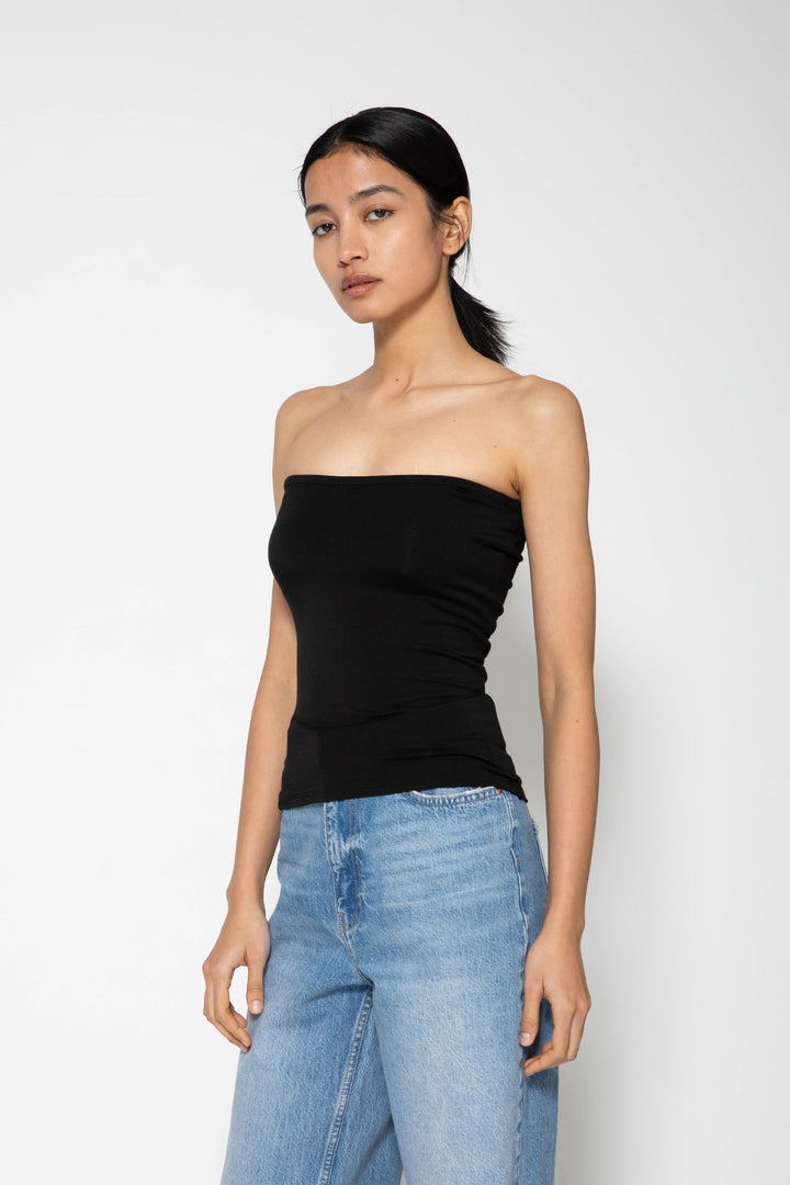 Woman modeling front of the black "Collagen Multi-way Cami "