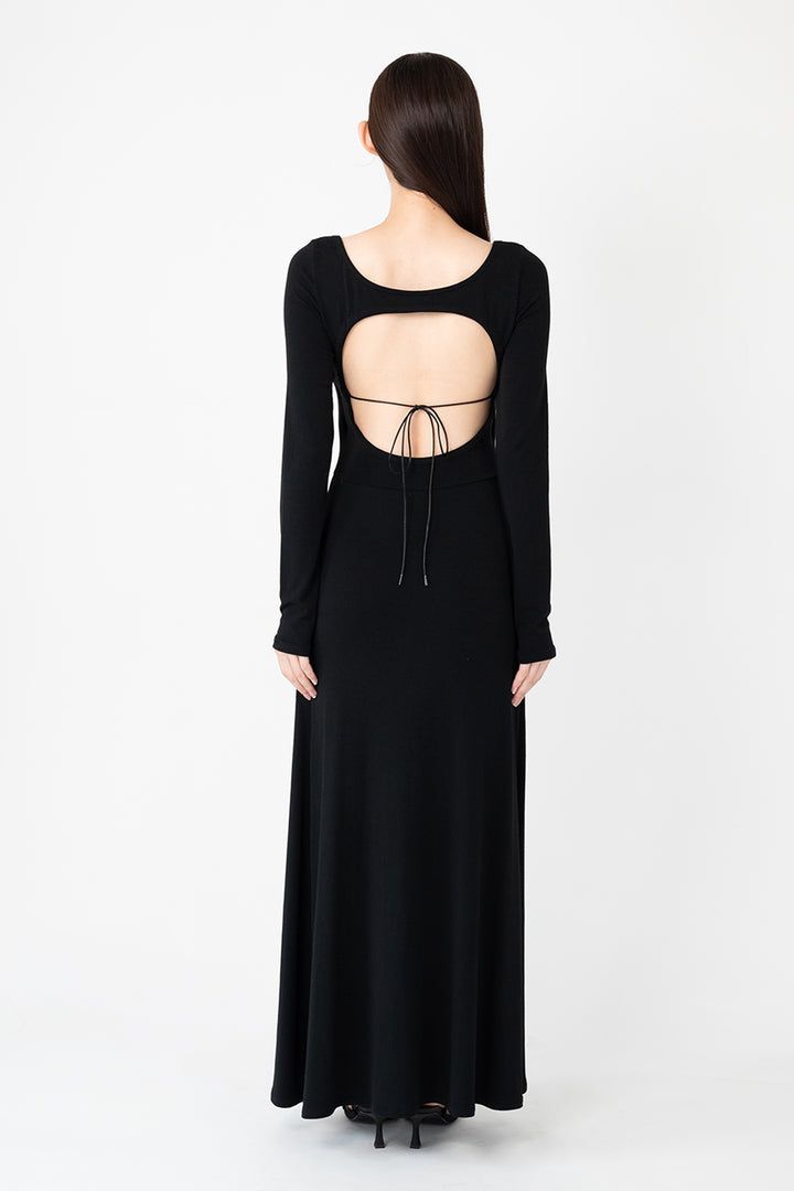 Woman modeling front of the black "Open Back Dress"