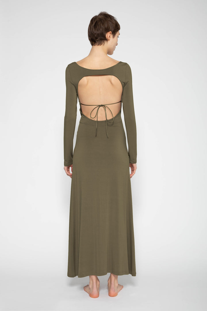 Woman modeling front of the olive "Open Back Dress"