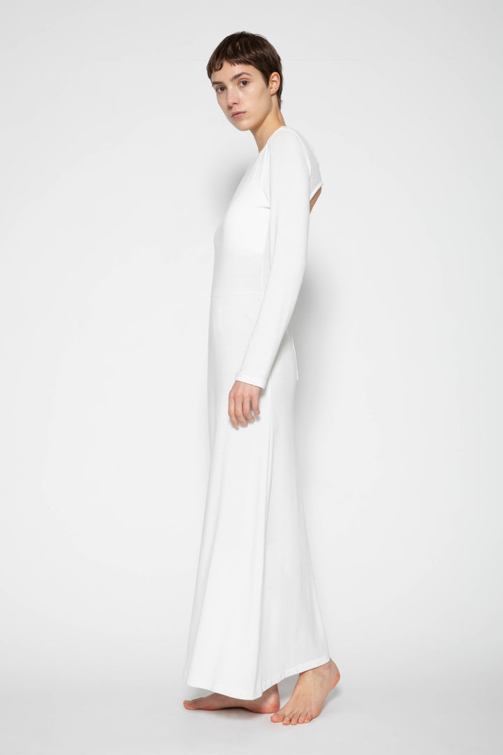 Woman modeling front of the white "Open Back Dress"