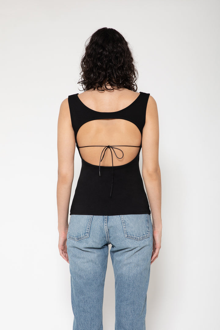 Woman modeling front of the black "Collagen Open Back Tank Top "