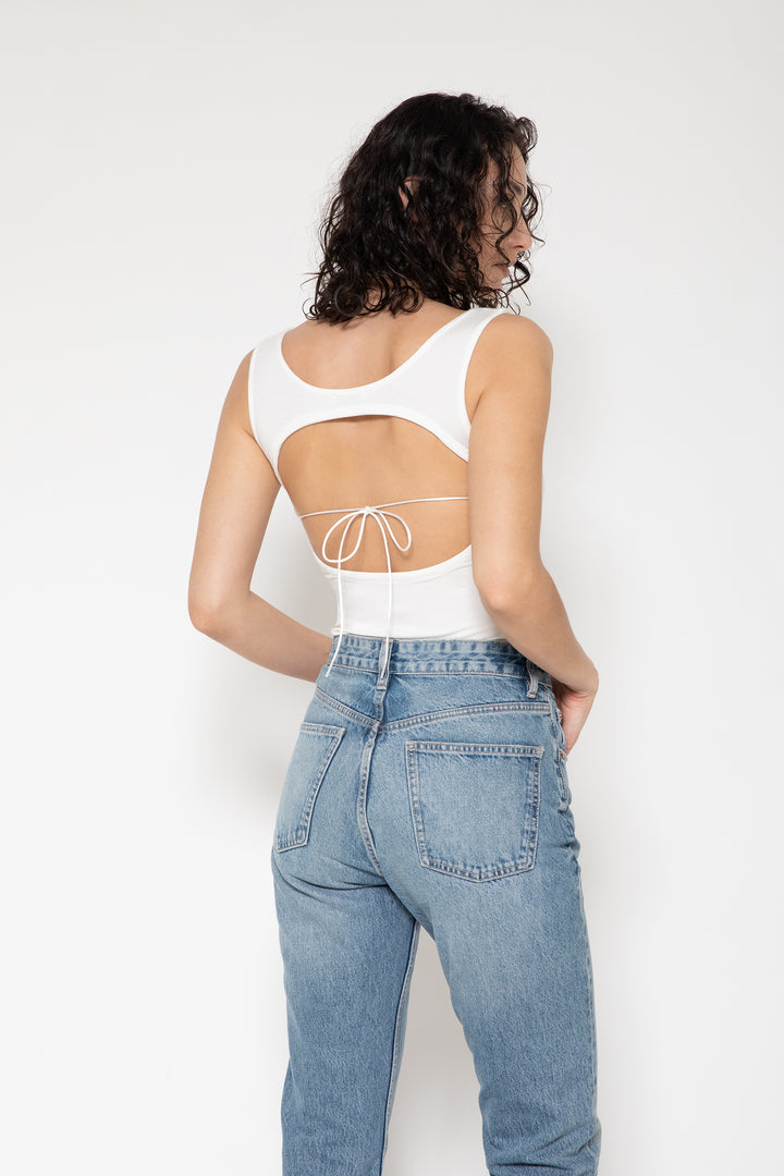 Woman modeling front of the white "Collagen Open Back Tank Top "