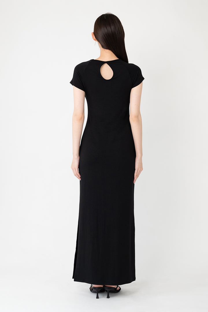 Woman modeling front of the black "Collagen Raglan Sleeve Dress "