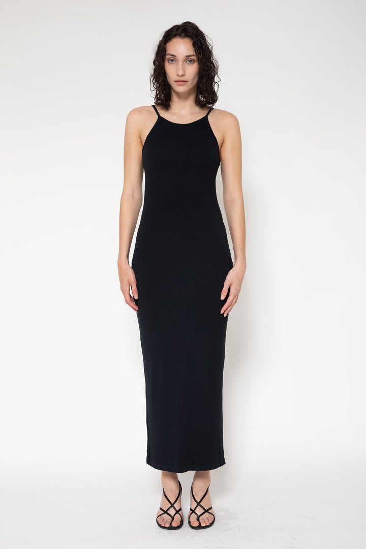 Woman modeling front of the black”Collagen Ribbed Back-slit Dress"