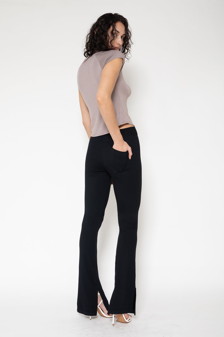 Woman modeling front of the black”Collagen Ribbed Flared Pants"