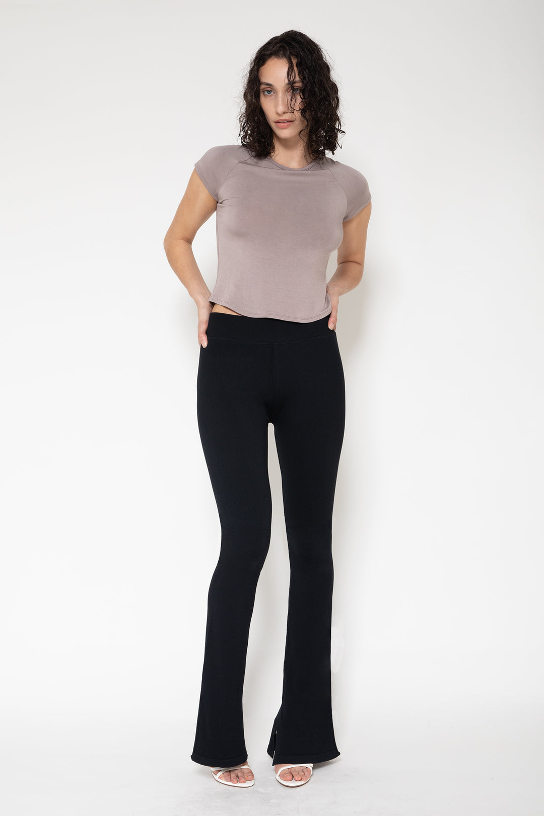 Woman modeling front of the black”Collagen Ribbed Flared Pants"