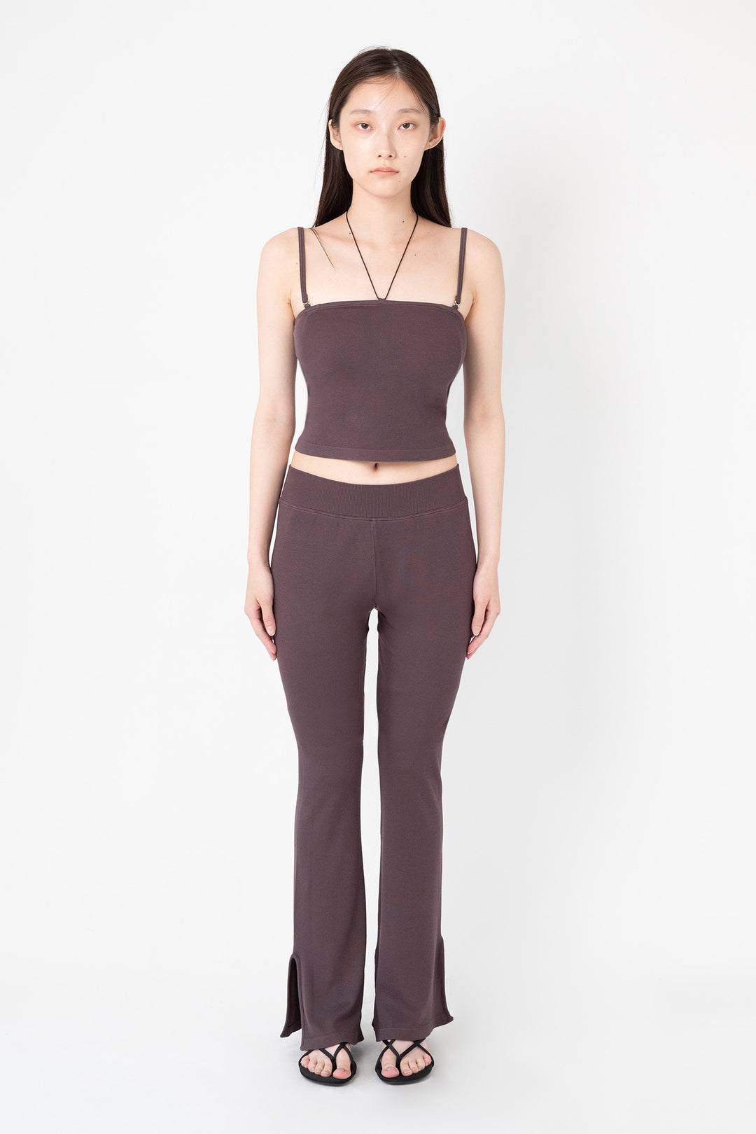 Woman modeling front of the dark brown”Collagen Ribbed Flared Pants"