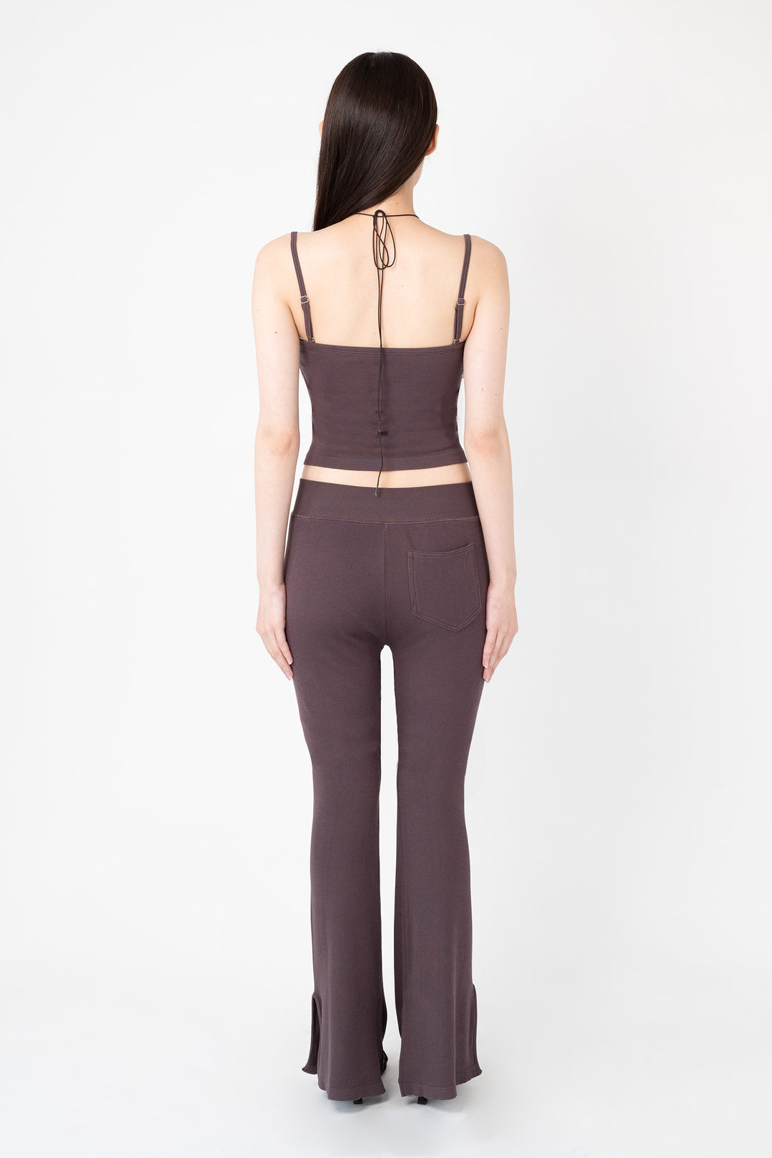 Woman modeling front of the dark brown”Collagen Ribbed Flared Pants"