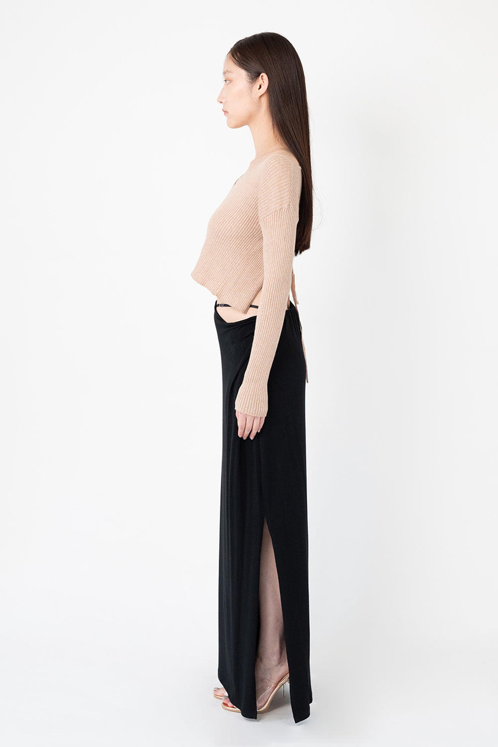 Woman modeling front of the black "Collagen Strappy Maxi Skirt”