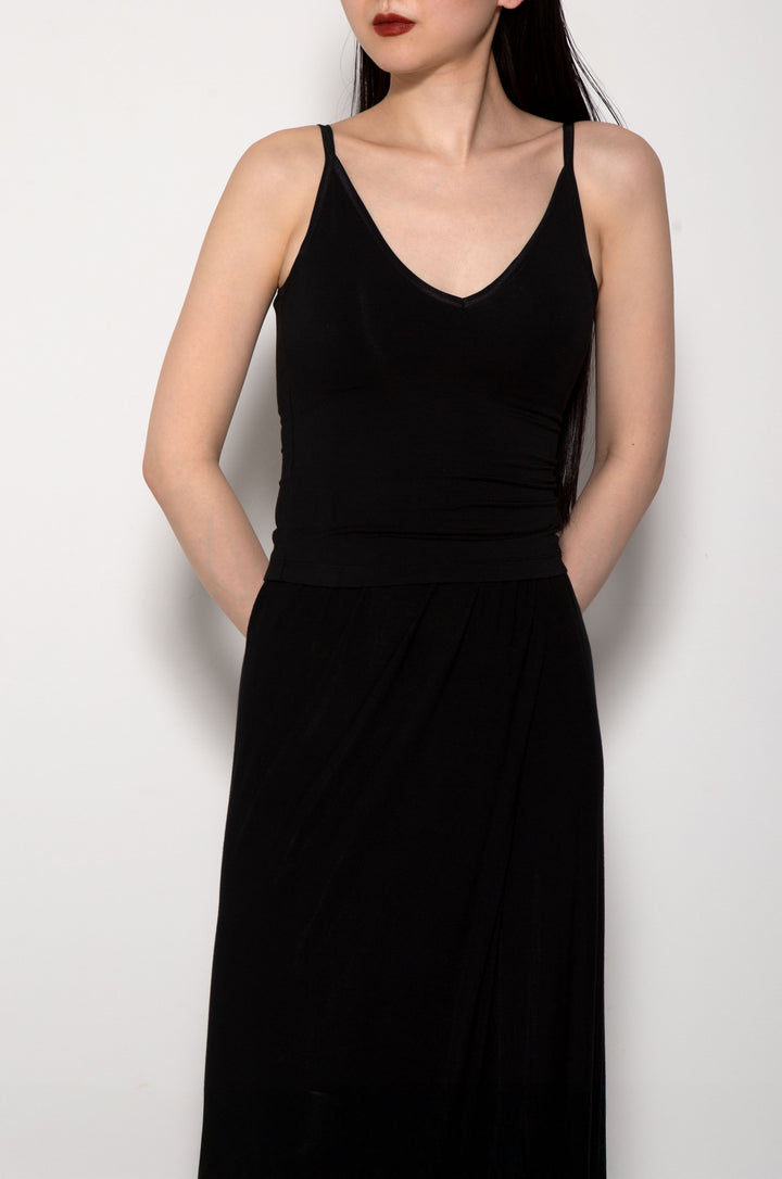 Woman modeling front of the black "Collagen Triangle Neck Cami"