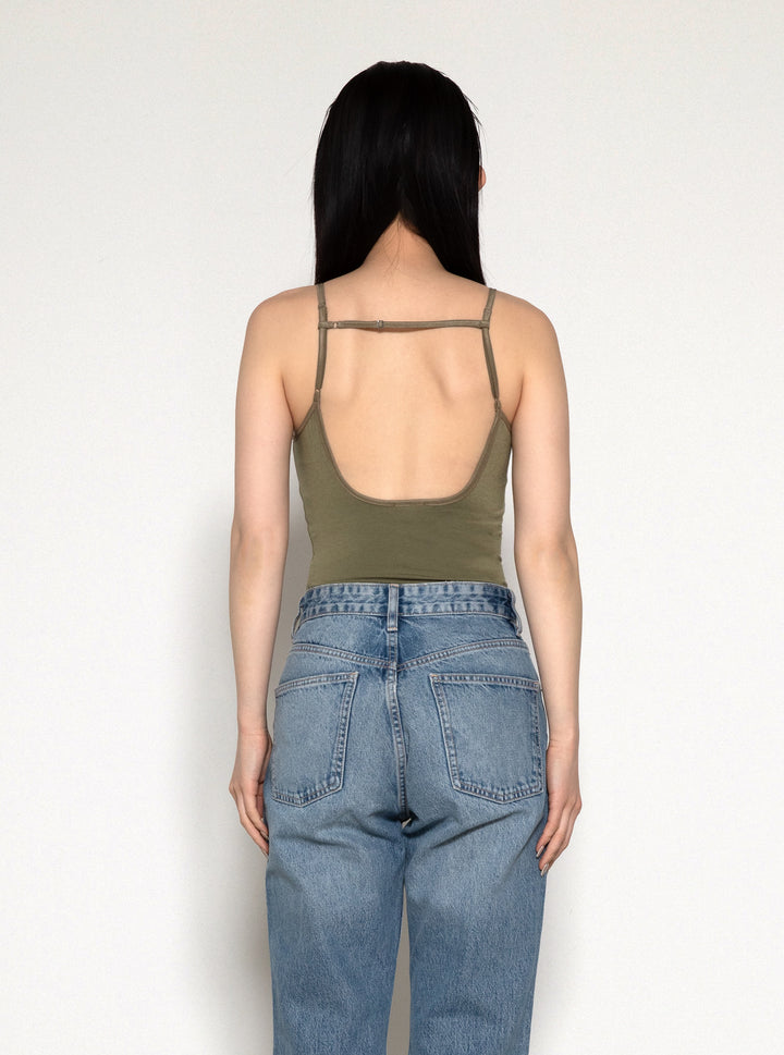 Woman modeling front of the olive "Collagen Triangle Neck Cami "