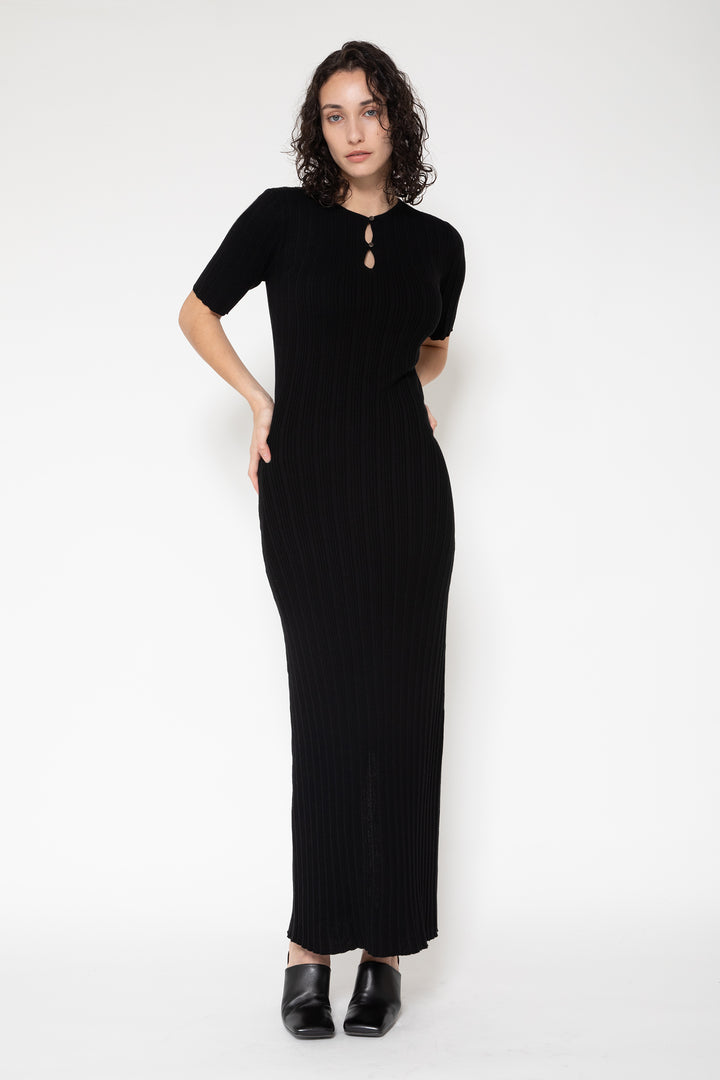 Woman modeling front of the black”Front Button Knit Dress"