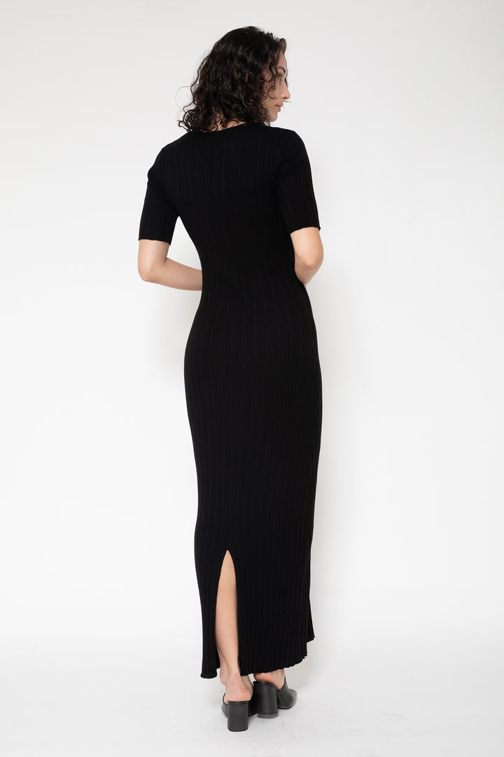 Woman modeling front of the black”Front Button Knit Dress"