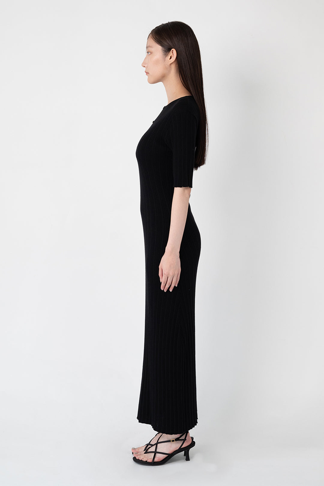 Woman modeling front of the black”Front Button Knit Dress"