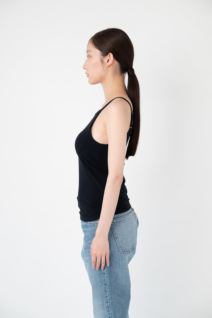 Woman modeling front of the black”Collagen Ribbed Tank Top"